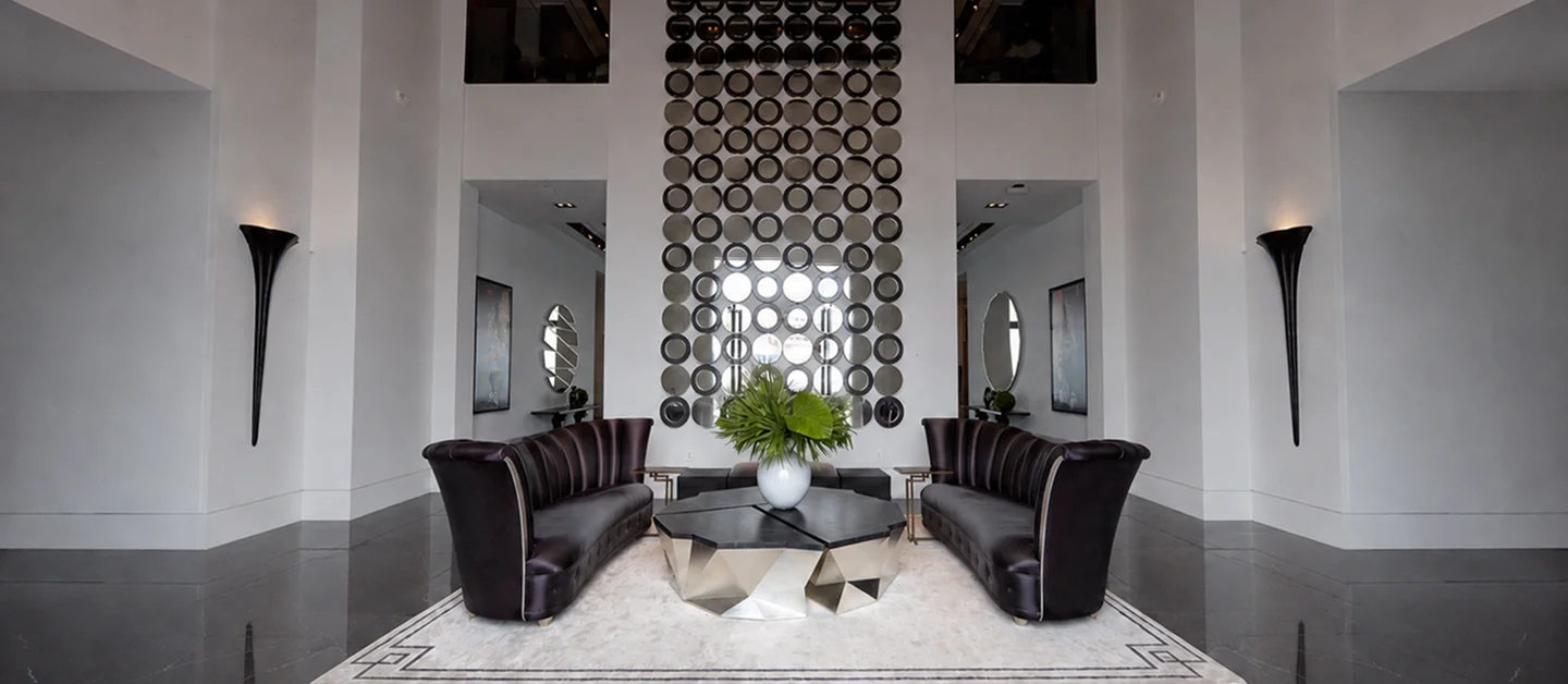 Christopher Guy Signature Collection featuring luxury leather sofas and decorative wall mirror showcase